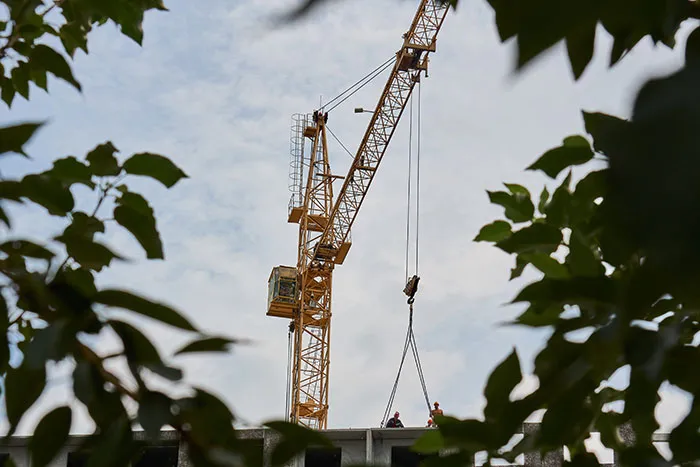 Construction site crane lifting materials hazard job