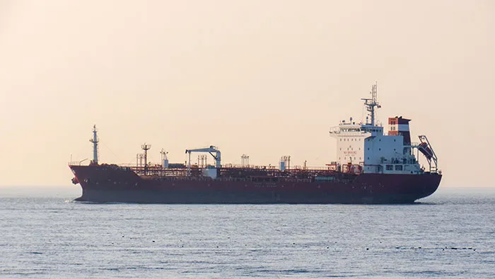 Large oil tanker ship sailing on open sea waters