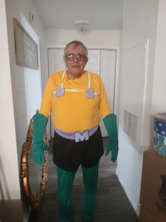 Elderly man wearing a Mermaid Man superhero costume, captured in one of the most wholesome moments.