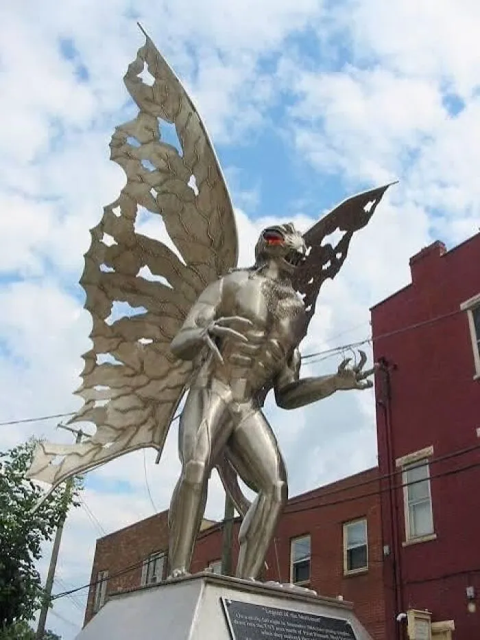 A tall, metallic statue of Mothman, showcasing a unique and bad example of public art.