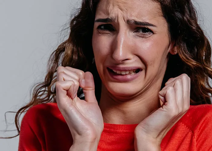 Frightened woman reacting to haunted house experience
