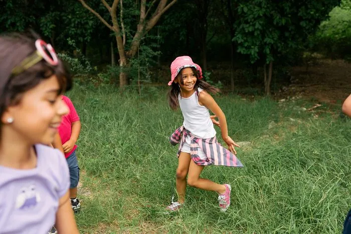 Young girl in a pink bucket hat playing outdoors, related to sobering stories of choices and outcomes