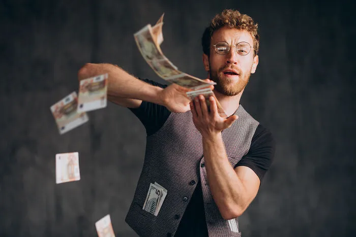 A man throwing money away, illustrating how life can fall apart from one wrong move.