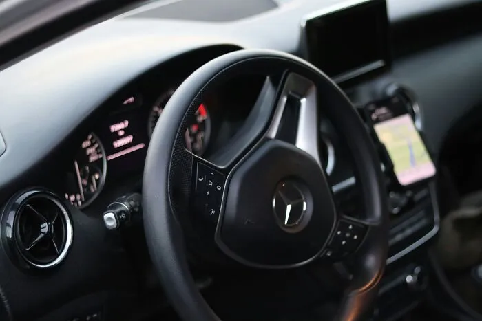 Close up of a car steering wheel, showing how one wrong move while driving can lead to everything falling apart.