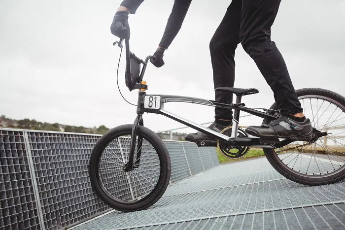 Cyclist performing a trick on a BMX bike, illustrating how quickly everything can fall apart with one wrong move.