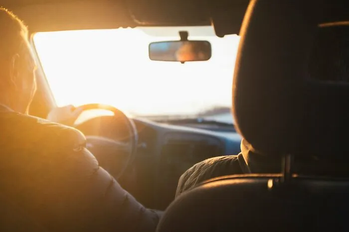 Driver navigating a car into bright sunset glare showing how quickly everything can fall apart on the road