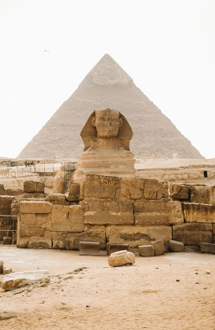 Great Sphinx statue with Pyramid in the background