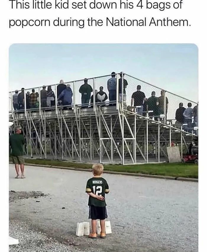 Hilarious rednecks meme with a young boy putting down popcorn bags to salute at a field.