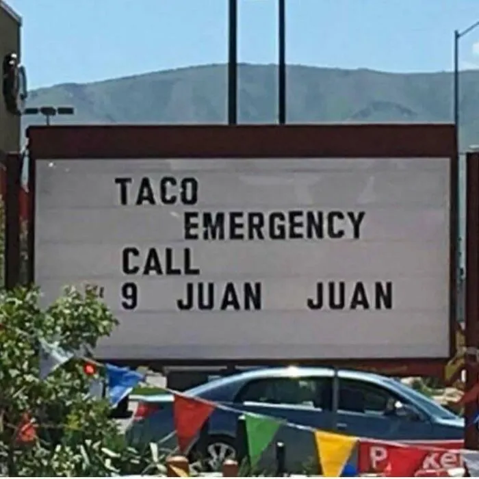 A restaurant sign reading Taco Emergency Call 9 Juan Juan featured in redneck memes.