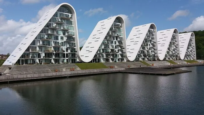 Wave-like residential buildings demonstrating bizarre architecture.