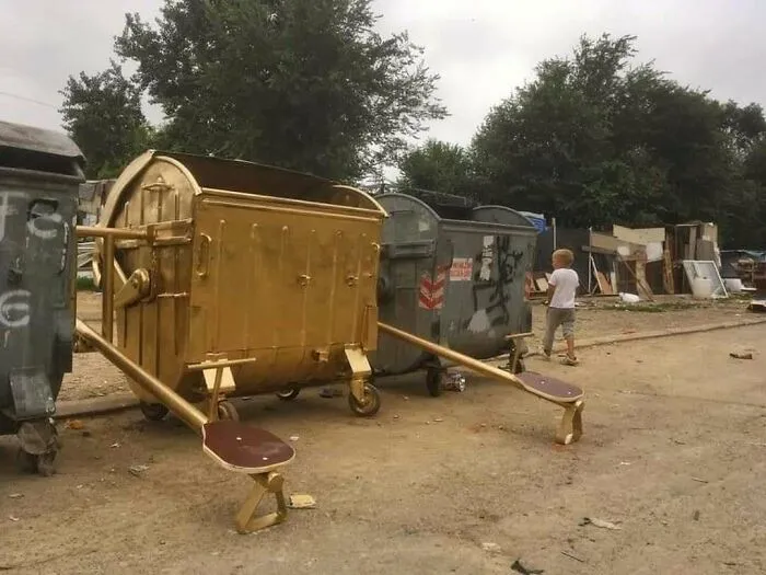 Slavic engineering gold dumpster modified into a playground seesaw
