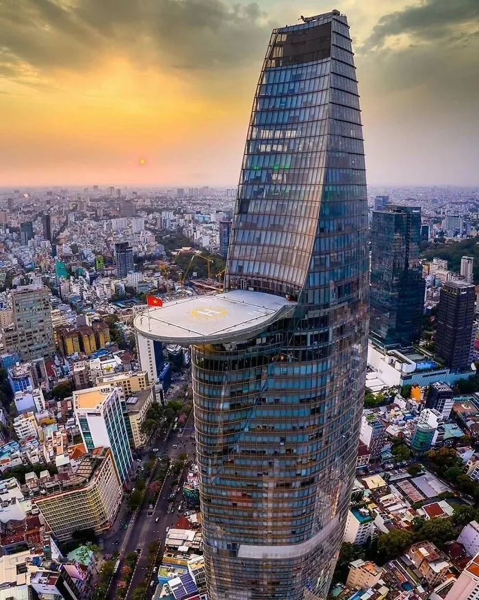 Twisting skyscraper with helipad at sunset strange buildings