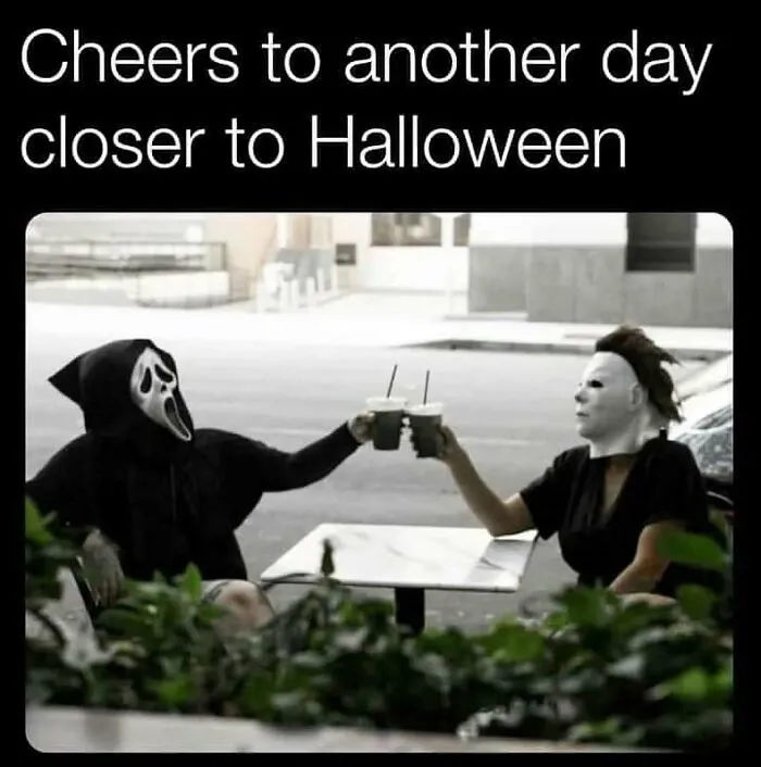 Spooky season meme of Ghostface and Michael Myers clinking iced coffee drinks outdoors.