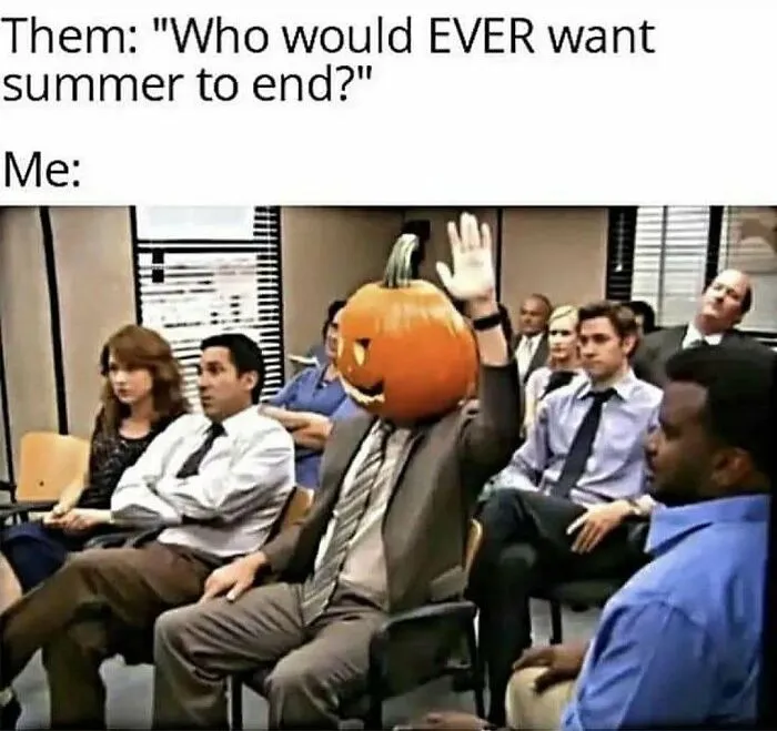 Spooky season meme showing Dwight from The Office with a pumpkin head raising his hand in a meeting.