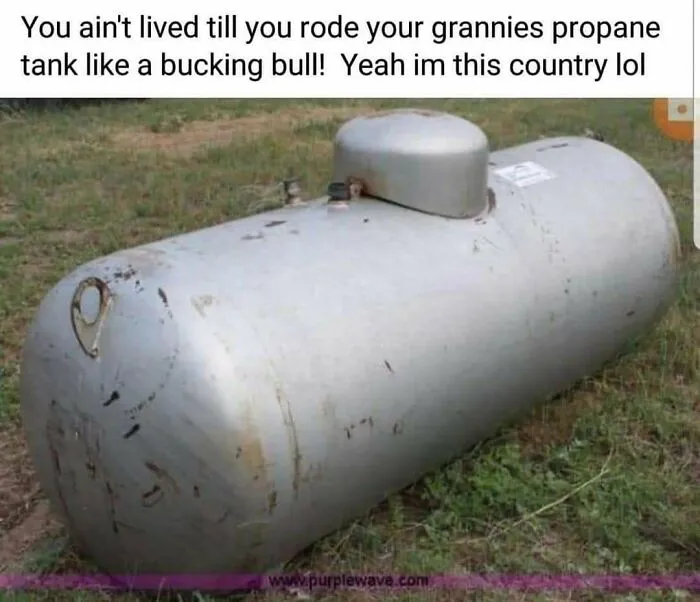 Large silver propane tank outdoors, part of hilarious rednecks memes content.