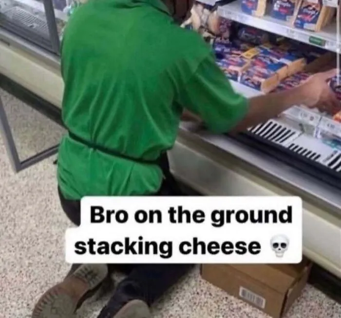 A grocery store worker stocking shelves on the floor in one of many absurd internet posts.
