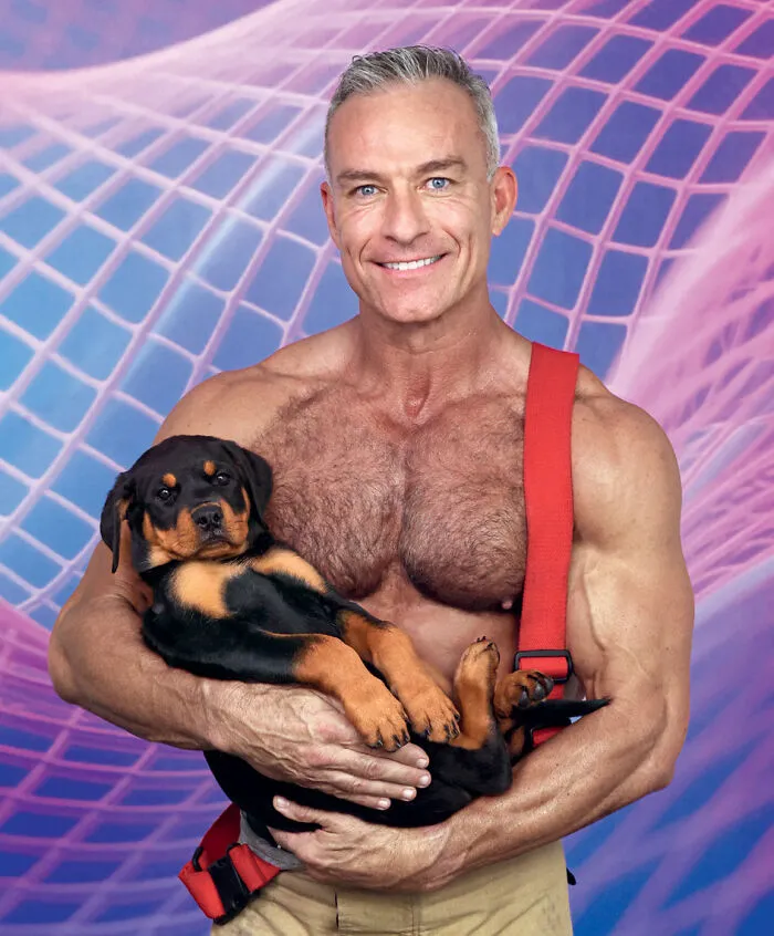 2027 Australian firefighters calendar muscular man holding Rottweiler puppy with purple background