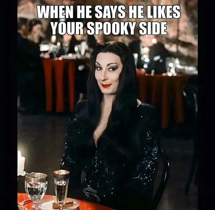 Spooky season meme showing Morticia Addams smiling about someone liking her dark side