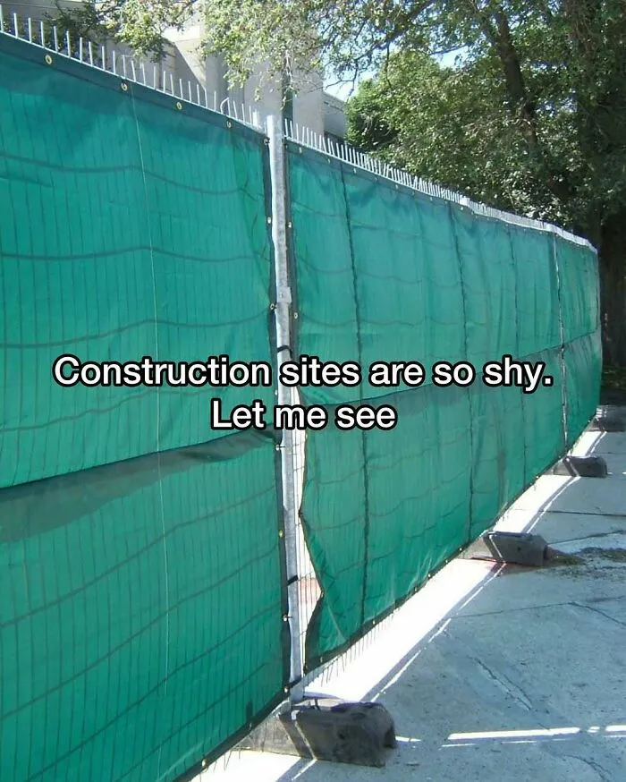 Green privacy fence at a construction site in cursed images
