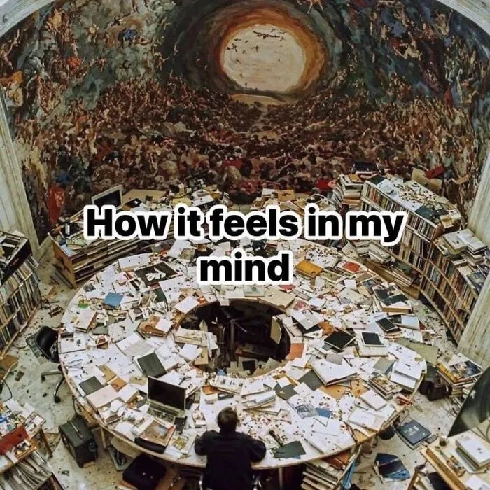 Relatable meme showing an overloaded, messy desk under a chaotic ceiling mural depicting an overwhelmed mind.