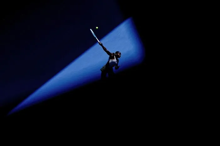 Tennis player serving spotlighted on dark background, best pics 2026 Siena International Photo Awards