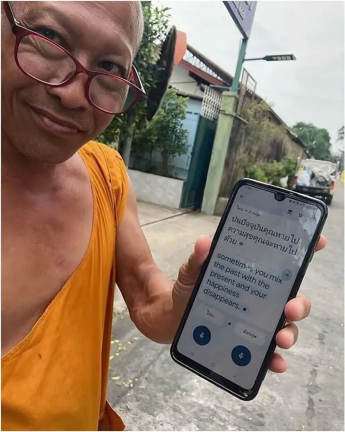 Out-of-context pics of a monk holding up a translated phone message.