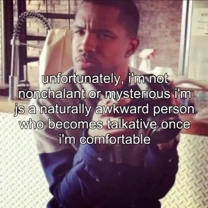 A confused man holding a camera in a funny meme about feeling awkward.