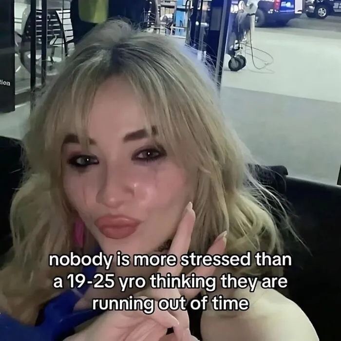 Crying girl holding up a peace sign, a hilariously relatable meme about stress and life.