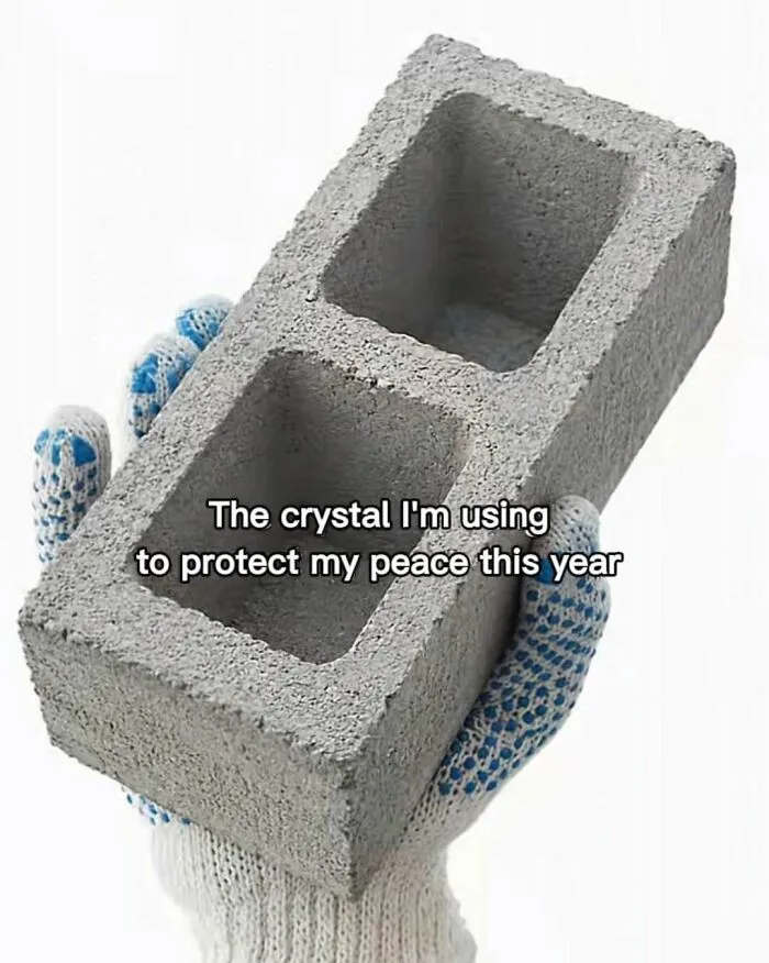 Funny memes with a cinder block labeled as a protective crystal held in a gloved hand.