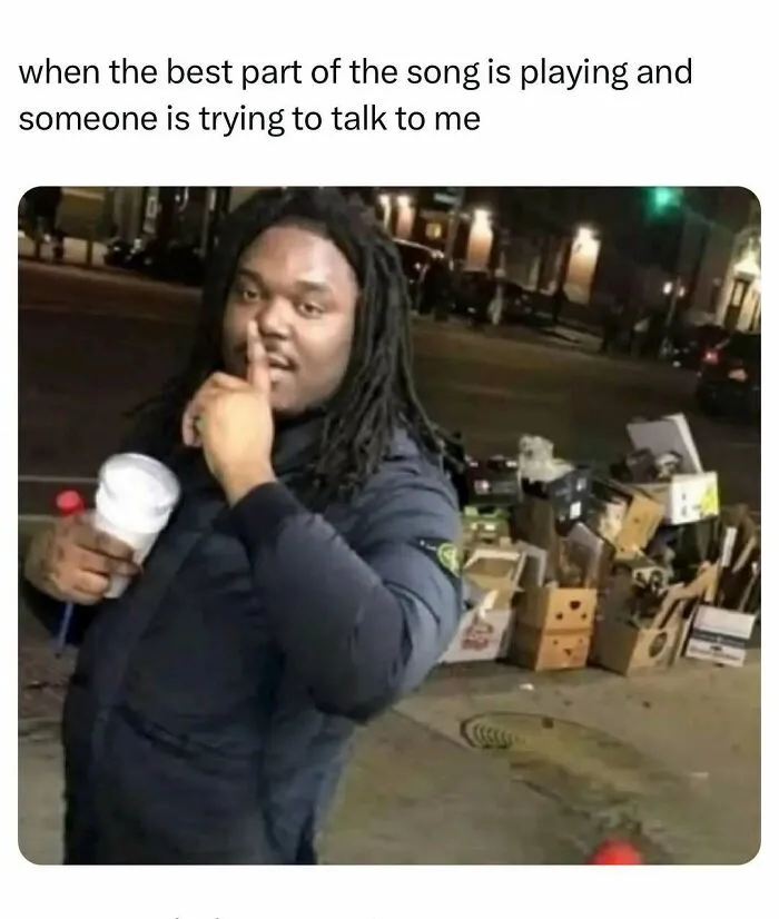 Man holding cup gestures to be quiet during best part of song meme