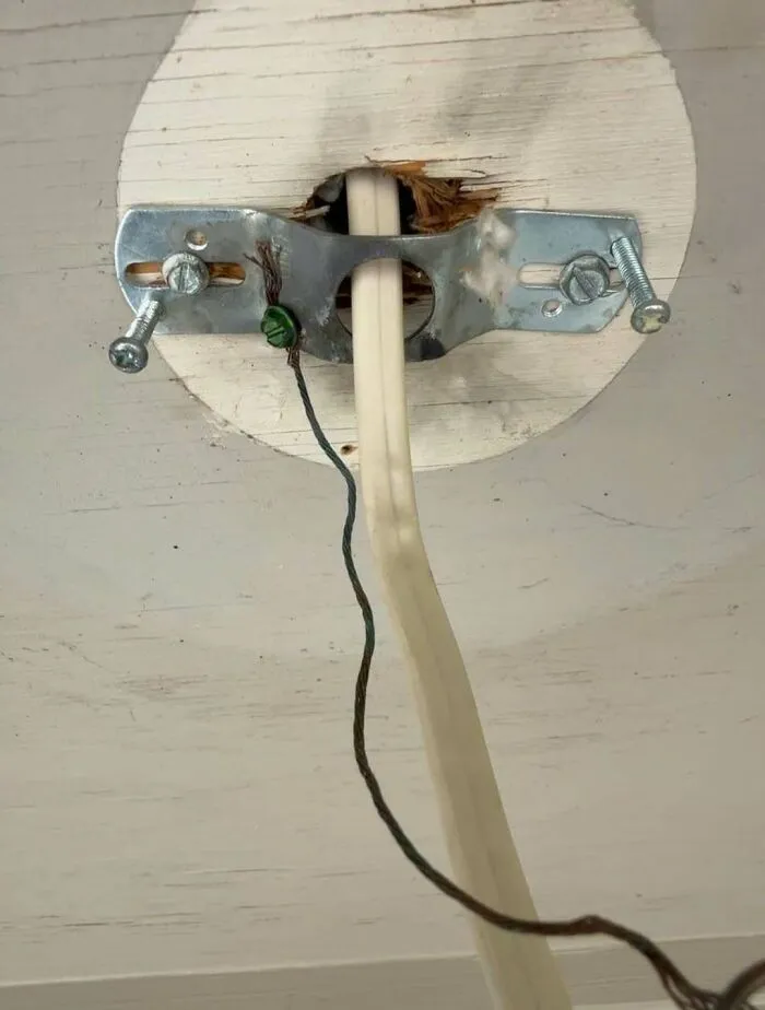 Close-up of a poorly executed ceiling light electrical wiring DIY project.
