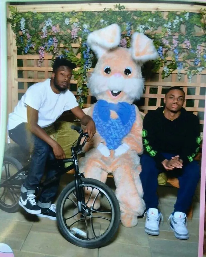 Hilarious pics of two young men posing awkwardly with a giant Easter Bunny mascot.