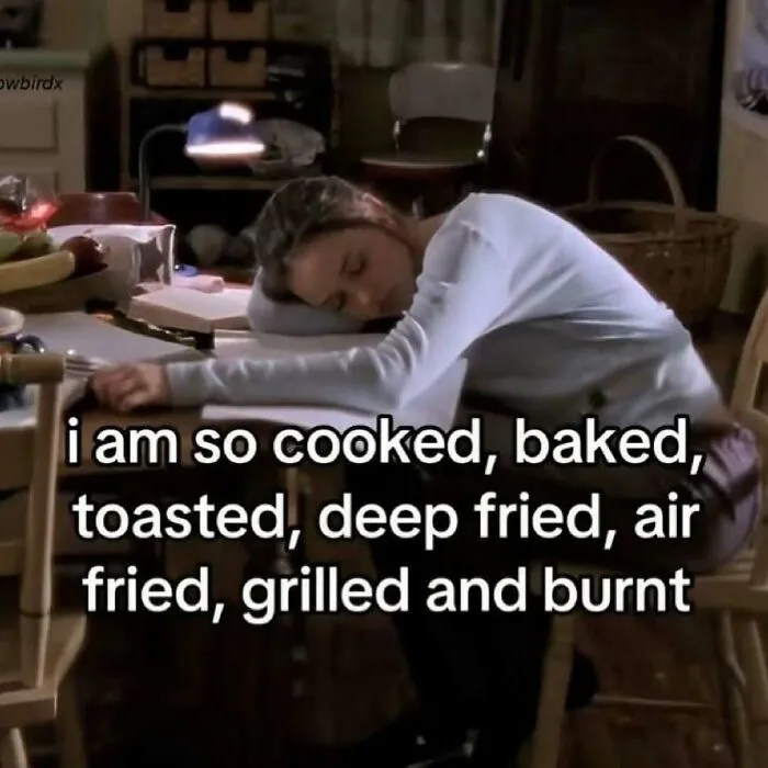 An exhausted girl sleeping on a desk in a meme about feeling completely burnt out.