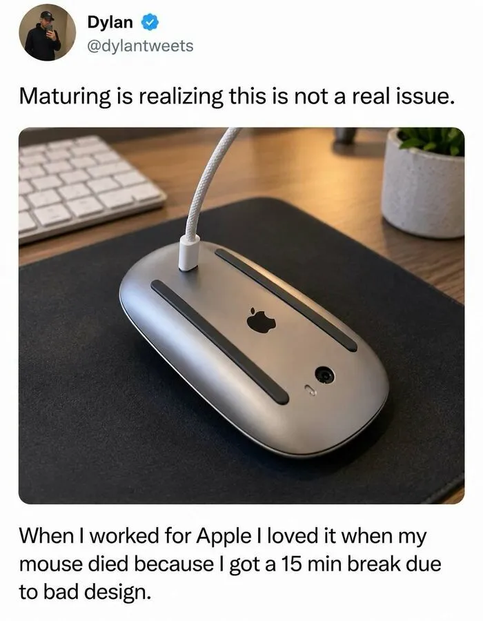Silly post featuring an Apple Magic Mouse charging upside down on a desk.