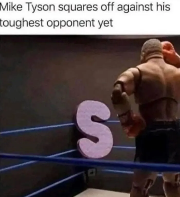 Mike Tyson action figure preparing to fight a giant letter S in a boxing ring, part of hilariously relatable memes.