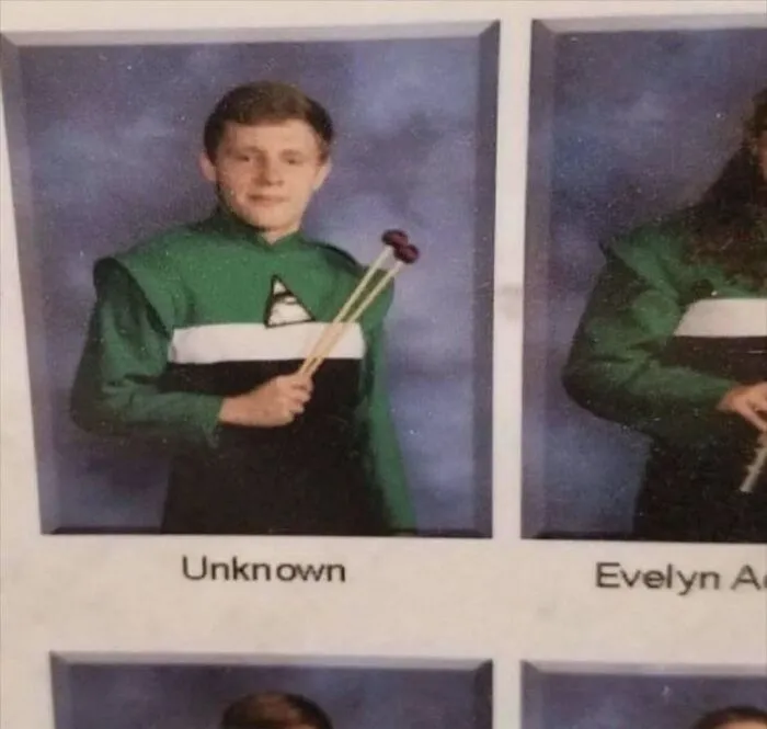 A hilarious yearbook photo showing a student labeled as Unknown holding drumsticks.