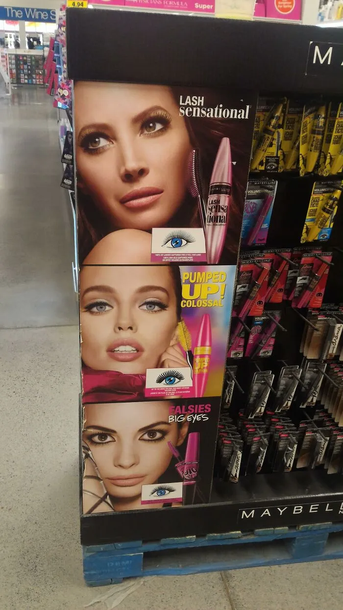 A perfectly confusing photo of a makeup display panel appearing to share an eye with another model.