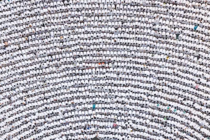 Aerial view of large crowd in uniform white clothing best pics 2026