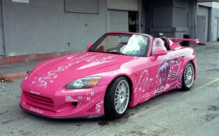 The iconic pink Honda S2000 movie prop car parked outside a studio
