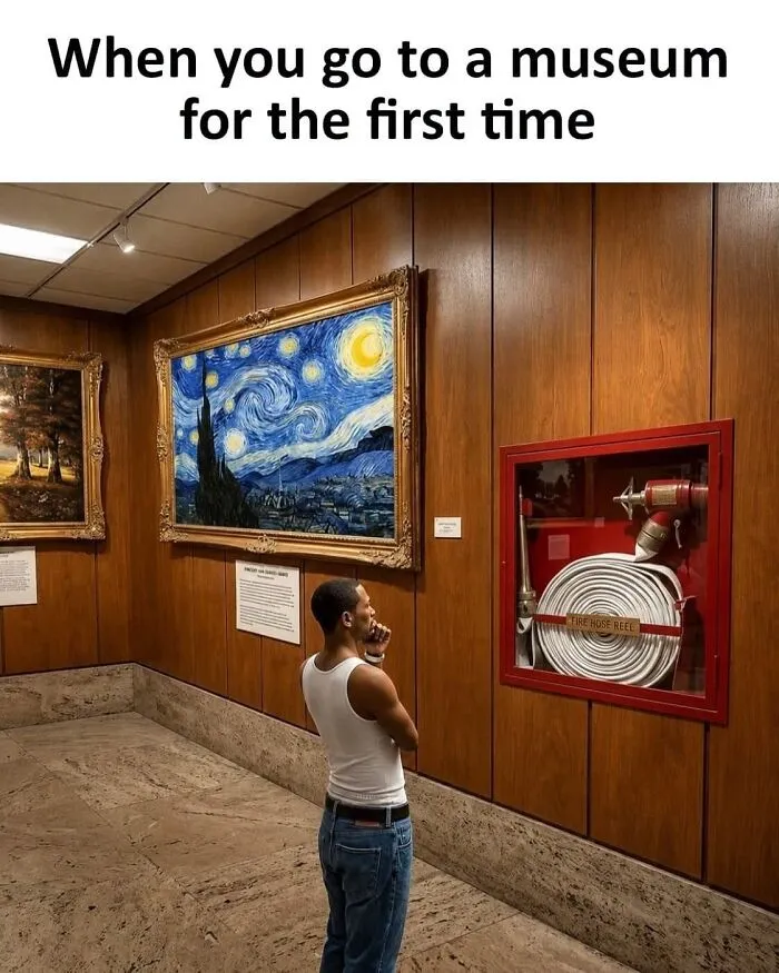 A man staring thoughtfully at a fire hose reel exhibit in an art gallery in a wholesome memes picture.