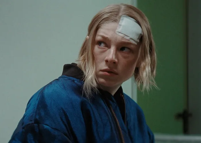 Trans actor Hunter Schafer with long blonde hair posing in a gold top in Hollywood