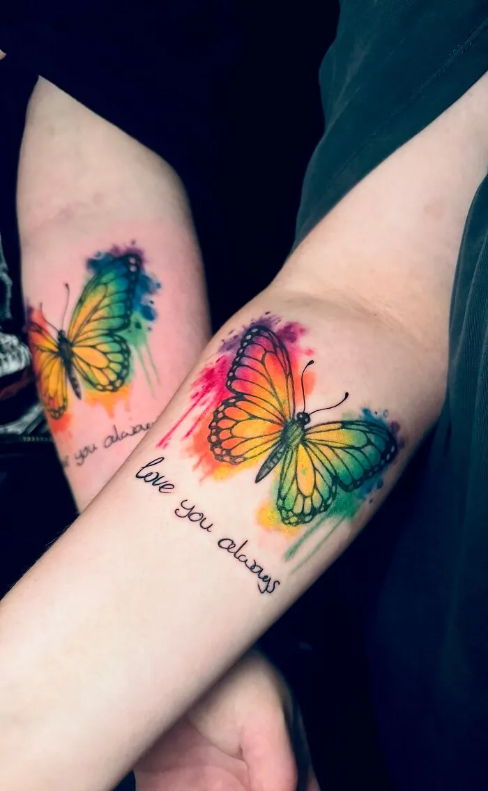 Colorful watercolor butterfly tattoos with love you always text on inner arms