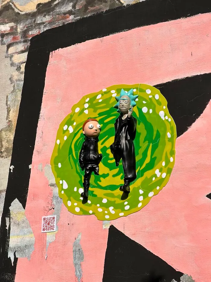 Rick and Morty street art installation of the pop culture characters on a pink wall in city streets
