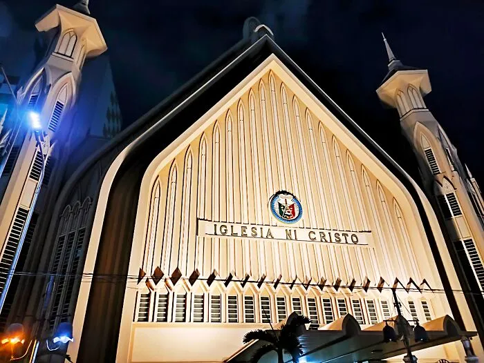 An illuminated Iglesia Ni Cristo building exterior representing modern religious cults.