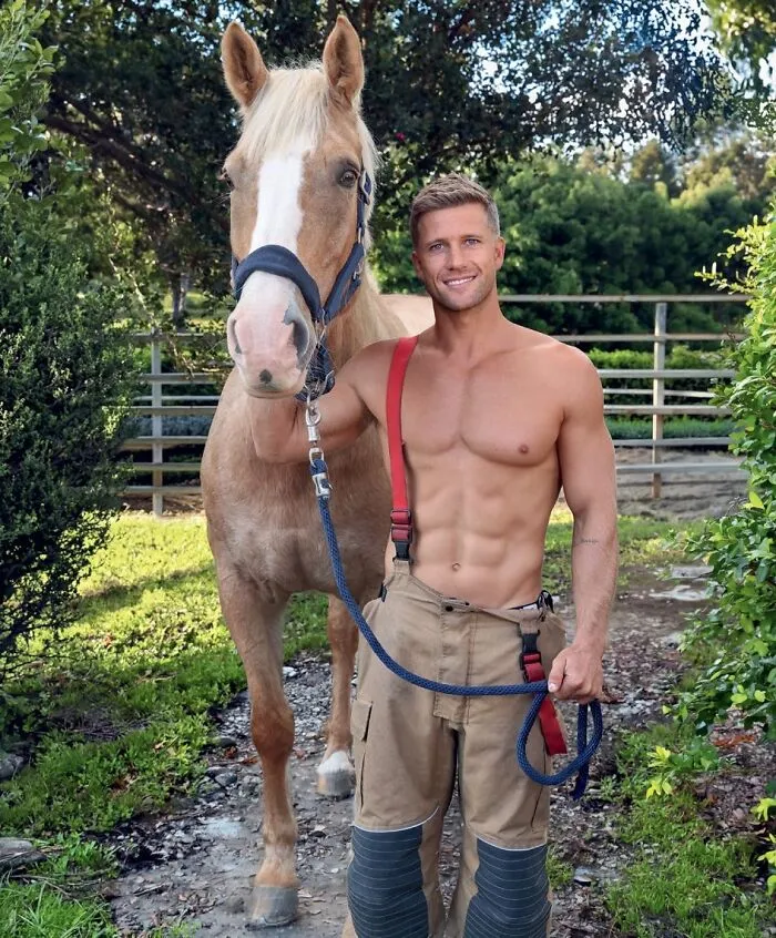 Smiling Australian firefighter with horse outdoors in 2027 firefighters calendar
