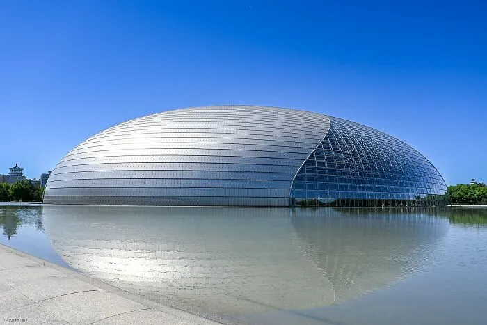 Futuristic buildings with bizarre shapes resembling a giant dome reflecting on water