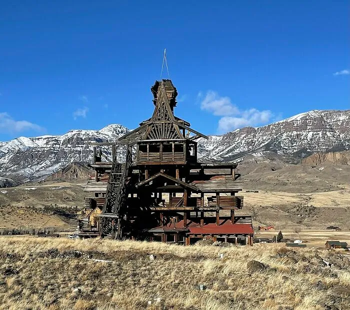 Unusual wooden building with complex structure in mountainous landscape