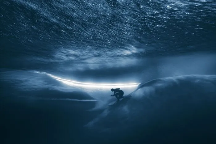Underwater surreal shot of surfer inside wave at Siena International Photo Awards