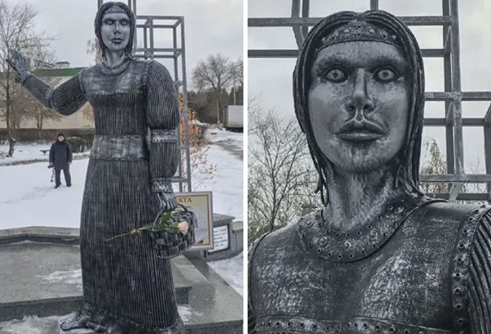 A creepy and bizarre public art statue of a woman with wide, staring eyes holding a flower basket in winter