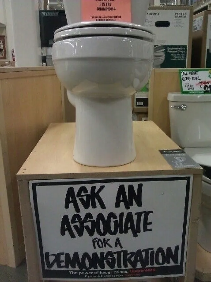 A display toilet in a store with a poorly phrased sign, representing an advertising fail.